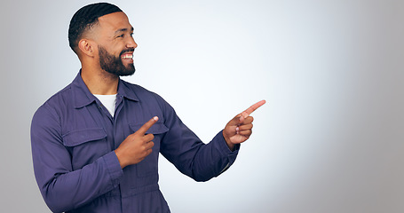 Image showing Happy man, pointing and mockup space for advertising or marketing against a studio background. Male person or salesman smile showing deal, list or information for advertisement, notification or alert
