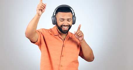 Image showing Happy man, headphones and dancing or listening to music for audio streaming against studio grey background. Male person enjoying sound track, podcast or radio with headset for rhythm on mockup space