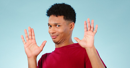 Image showing Shock, surprise and man with hands in gesture for news, announcement or protest in studio portrait. Wow face, no and stop, person with drama emoji for alarm, danger or gossip alert on blue background