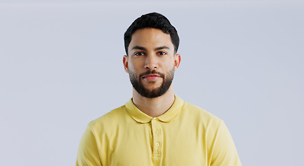 Image showing Man, fashion and confidence in studio portrait for trendy style, beard and clothes by white background. Student guy, latino person and model with yellow golf tshirt for with cool aesthetic in Mexico