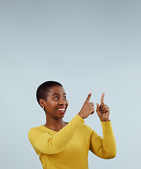 Image showing Mockup, smile and black woman with hand pointing up in studio for presentation on grey background. News, announcement and African female model show feedback, checklist or schedule, promo or platform