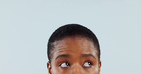 Image showing Idea, space and eyes with woman in studio for mockup, planning and opinion. Question, why and confused with closeup face of african person thinking on grey background for guide, remember and choice