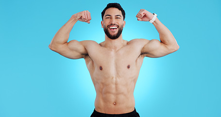 Image showing Happy man, portrait and muscle flex of bodybuilder in fitness isolated against a blue studio background. Male person, athlete or model smile showing strength, power or results for workout on mockup