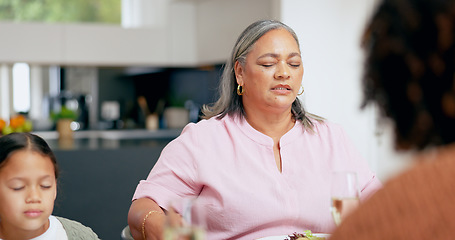 Image showing Praying, senior woman and family at table for dinner, lunch or breakfast and holding hands for grace. Christian, religion and grandmother with girl giving gratitude, prayer or thank you god for food