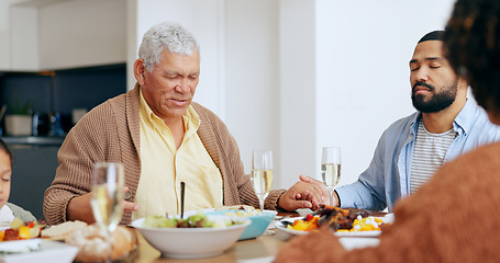 Image showing Food, thanksgiving and a family praying at the dinner table of their home together for eating a celebration meal. Love, holidays and a group of people saying grace for health, diet or nutrition