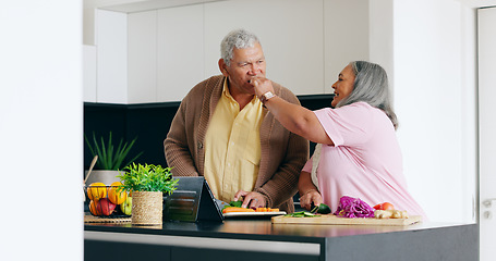 Image showing Senior couple, cooking and taste in a kitchen with tablet for recipe, research or online tutorial at home. Love, food and old people with digital app for nutrition, blog or vegetables for meal prep