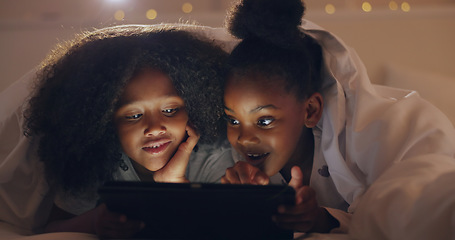 Image showing Sisters, girl or tablet at night with internet for movie, cartoon or streaming with blanket on bed in bedroom. Family, kids or children with technology in the dark for film, video and bonding at home