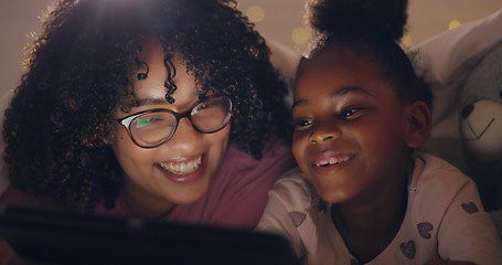 Image showing Mom, daughter and tablet at night with internet for movie, cartoon or streaming with blanket on bed in bedroom. Family, woman and girl child with technology in the dark for film, video and bonding