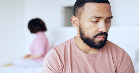 Image showing Face, divorce and breakup with a man on the bed in his home after fighting with his wife as a couple. Thinking, sad or conflict with a husband in the bedroom of an apartment looking depressed