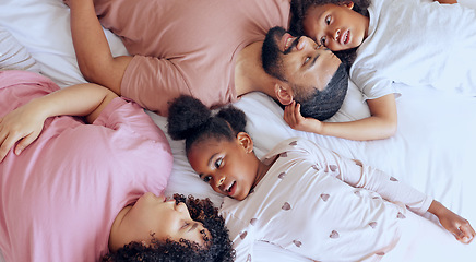 Image showing Parents, kids and bonding on bed with relax, peace and happiness in bedroom of family home in morning. People, woman or man with children and pyjamas for rest, love and care with smile in house