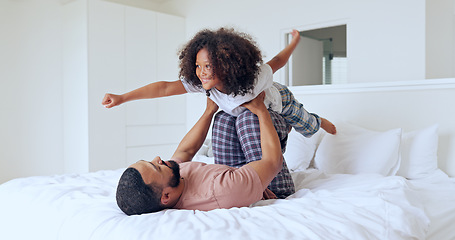 Image showing Dad, daughter and airplane on bed with playing, bonding and freedom for happiness or trust in bedroom of home. Family, man and girl child with lifting in knees with balance, relationship and love