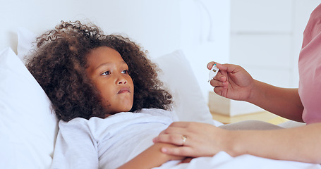 Image showing Sick, thermometer or a girl with a fever in bed to relax or recover and a parent in the home to care or check. Family, kids and an unhealthy female child in the bedroom of an apartment with a fever