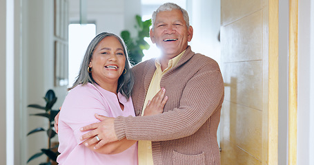 Image showing Portrait, love and smile with a senior couple in their retirement home together for friendly welcome. Happy, hug or embrace with an elderly man and woman in the doorway entrance to their apartment