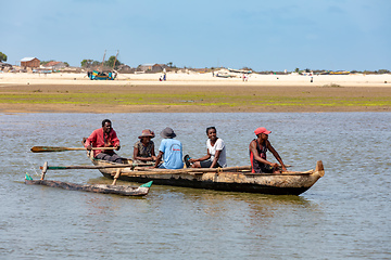 Image showing Malagasy family in traditional wooden boat crossing River in Morondava, Madagascar.