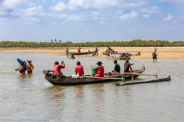 Image showing Malagasy family in traditional wooden boat crossing River in Morondava, Madagascar.