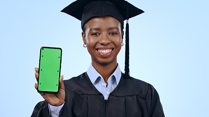 Image showing Graduate, woman and phone green screen for university marketing, contact or information on blue background. Portrait of graduation student with mobile app mockup, e learning and education in studio