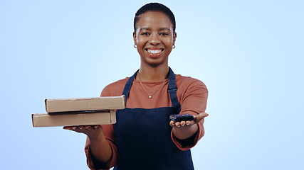 Image showing Woman, pizza boxes and payment machine for delivery, e commerce, and POS customer service on blue background. Portrait of african cashier and fast food order, fintech or digital transaction in studio