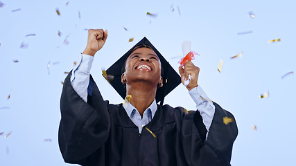 Image showing Graduation, woman student and confetti celebration, success and achievement of college or university in studio. Excited African graduate with award, diploma and yes for education on a blue background