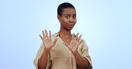 Image showing Black woman, portrait and hands for no, rejection or refusal isolated against a blue studio background. Face of worried African female person or model in stop, halt or not interested on mockup space
