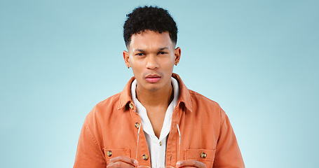 Image showing Man, confused and portrait in studio with thinking mindset, doubt and problem with choice in mockup. Young person, brazilian and unsure face with question, idea error and decision by blue background