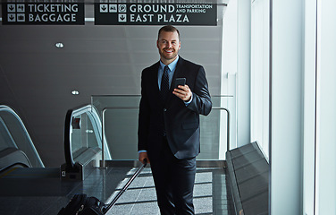 Image showing Travel, portrait or businessman in airport with phone, luggage or suitcase on social media. Booking, happy entrepreneur or corporate worker texting to chat on mobile app on international flight