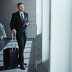 Image showing Business man, phone and bag in airport hallway for smile, thinking and vision by window for international travel. Entrepreneur, luggage and smartphone with flight schedule for immigration in London