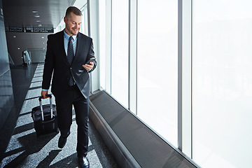 Image showing Business man, phone and texting in airport for smile, luggage or email notification on international travel. Entrepreneur, bag or smartphone for flight schedule, global immigration or idea in London