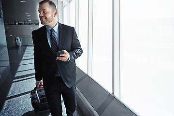 Image showing Business man, smartphone and luggage in airport hallway with smile, thinking or idea for international travel. Entrepreneur, suitcase and phone with flight schedule for global immigration in London