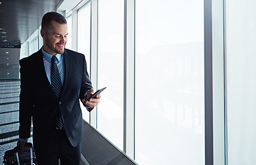 Image showing Corporate man, phone and window in airport corridor for reading, thinking or communication on business travel. Entrepreneur, luggage and smartphone for flight schedule or global immigration in London