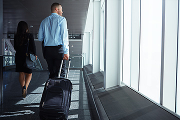 Image showing Flight, walking or back of business people in airport with suitcase, luggage or baggage on company trip. Hall, plane or corporate workers in lobby on a global journey on international travel together