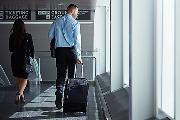 Image showing Hall, walking or back of business people in airport with suitcase, luggage or baggage on company trip. Thinking, plane or corporate workers in lobby on global journey on international travel together