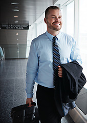 Image showing Walking, happy or man in airport thinking of company trip with suitcase or luggage for commute. Proud businessman, smile or corporate worker in hall for journey, flight or international travel