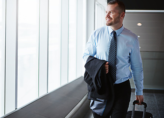 Image showing Walking, manager or businessman in airport thinking of company trip with suitcase or luggage. Happy, window or corporate worker in hallway for commute journey or international travel with pride