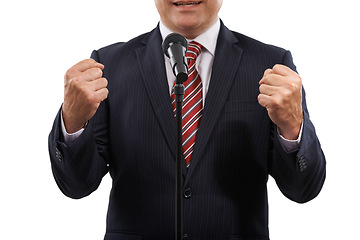 Image showing Microphone, speaker and hands of business man on a white background for presentation, speech and seminar. Debate, public speaking and politician for conference, convention and talking in studio