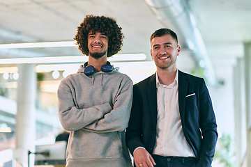 Image showing In a modern startup office setting, a business director and a young African American entrepreneur sit surrounded by their colleagues, embodying diversity and teamwork in the corporate world.