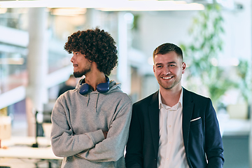 Image showing In a modern startup office setting, a business director and a young African American entrepreneur sit surrounded by their colleagues, embodying diversity and teamwork in the corporate world.