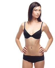 Image showing Young woman, portrait and underwear in lose weight, slim body or diet against a white studio background. Attractive female person or model in lingerie, bikini or posing for detox, health and wellness