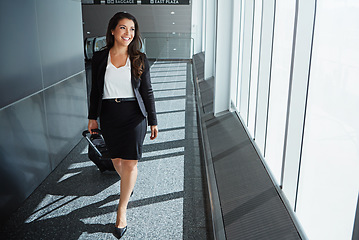 Image showing Flight, thinking or happy woman on business trip walking with suitcase, baggage or luggage. Smile, entrepreneur or corporate worker by window in lobby for travel journey in an international airport