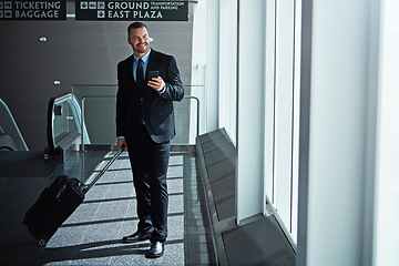 Image showing Travel, thinking or business man in airport with phone, luggage or suitcase on social media. Booking, happy entrepreneur or corporate worker texting to chat on mobile app on international flight