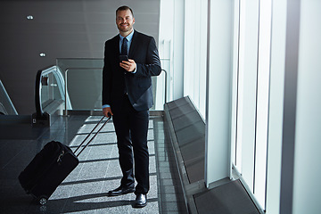 Image showing Smile, portrait or businessman in airport with phone, luggage or suitcase in waiting room to travel. Social media, happy entrepreneur or corporate worker texting on mobile app on international flight