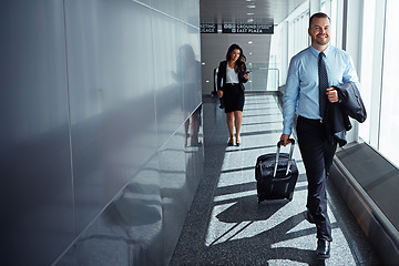 Image showing Business man, woman and suitcase for walking at airport, thinking or vision on international travel. Professional people, luggage or happy in corridor, idea or flight for global immigration in London