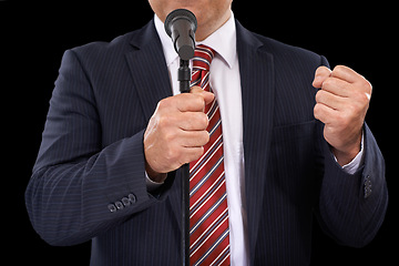 Image showing Microphone, speech and hands of business man on black background for presentation, speaker and seminar. Leader, public speaking and person talking for conference, tradeshow or communication in studio