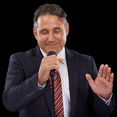 Image showing Microphone, speaker and business man on black background for presentation, speech and seminar. Professional, public speaking and worker talking for conference, tradeshow and communication in studio