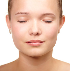 Image showing Woman, eyes closed and skincare studio for clear glow, hygiene on white background. Female person, model and natural soft for dermatology confidence for health wellness, calm shine or collagen
