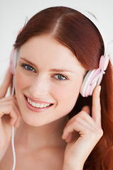 Image showing Smile, headphones and portrait of woman in a studio listening to music, playlist or album. Happy, excited and young female model from Canada streaming a song or radio isolated by white background.