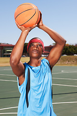 Image showing Basketball, player and shoot on outdoor court for fitness challenge or sports train for game, match as athlete. Black man, score point for summer goal dunk or competition winner, cardio or confident