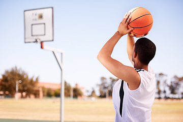 Image showing Man, player and shot on basketball outdoor court for point jump athlete, game challenge in summer. Male person, arm and sport score at hoop for exercise fun or fitness training action, active in park