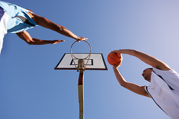 Image showing Men, player and basketball game at outdoor court or low angle of challenge team, dunk on rival. Male people, hoop or score point in summer park on fitness match or competition, athlete at blue sky