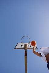 Image showing Man, basketball and low angle shot for point as jump athlete, game challenge or sky mockup. Male person, hand and string dunk score at hoop for exercise fun or fitness training sport, player on court
