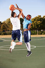 Image showing Basketball, training and men jump on court in game with ball, workout and outdoor exercise in sports. Fitness, competition and athlete shooting for a goal, challenge or stretching to score in match